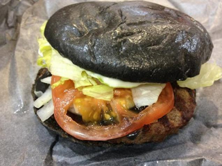 Illustration for article titled Burger King's all-black burger looks absolutely disgusting in real life